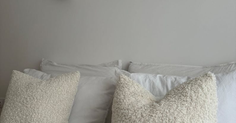 Sconces - Bed with Pillows in White Faux Fur Covers